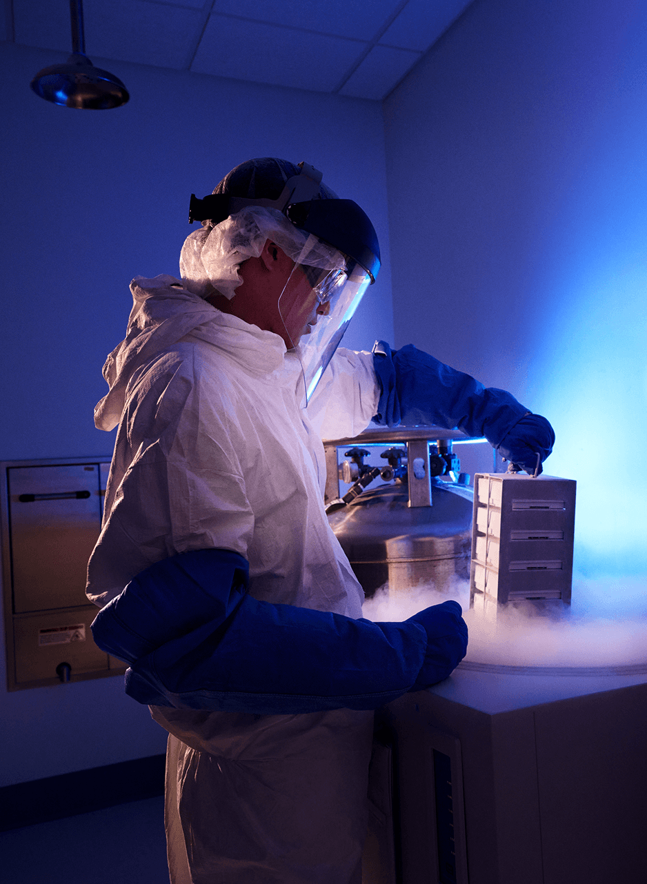 Scientist pulling box out of cryogenic storage