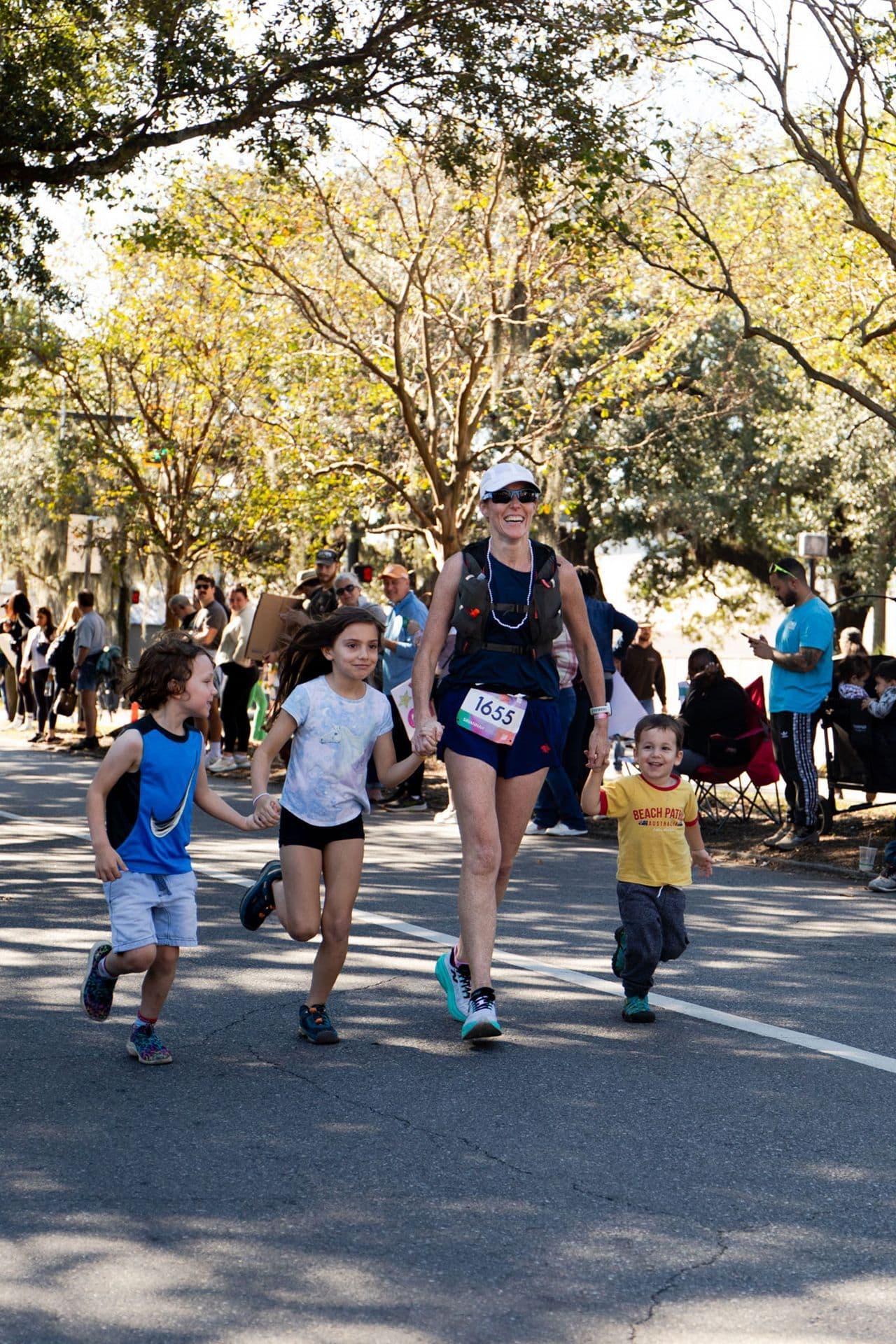 Every Woman's Marathon - mom holding kids hands